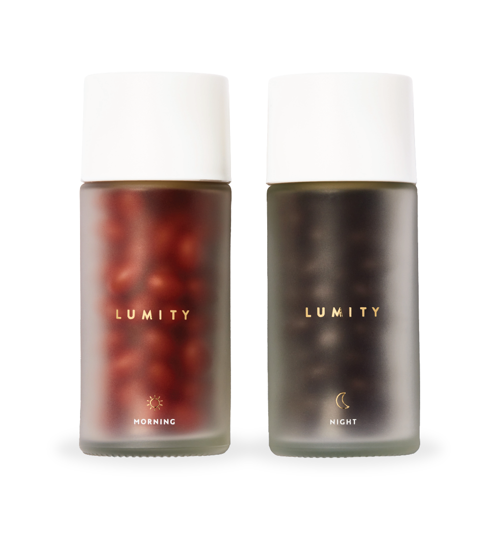 Lumity morning (reddish capsules) and night (dark capsules) supplements in frosted glass bottles, eye-level product shot