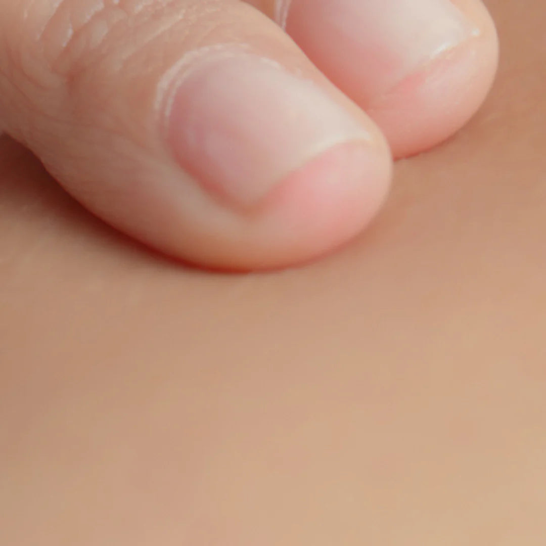 Close-up of a person's thumb on a skin