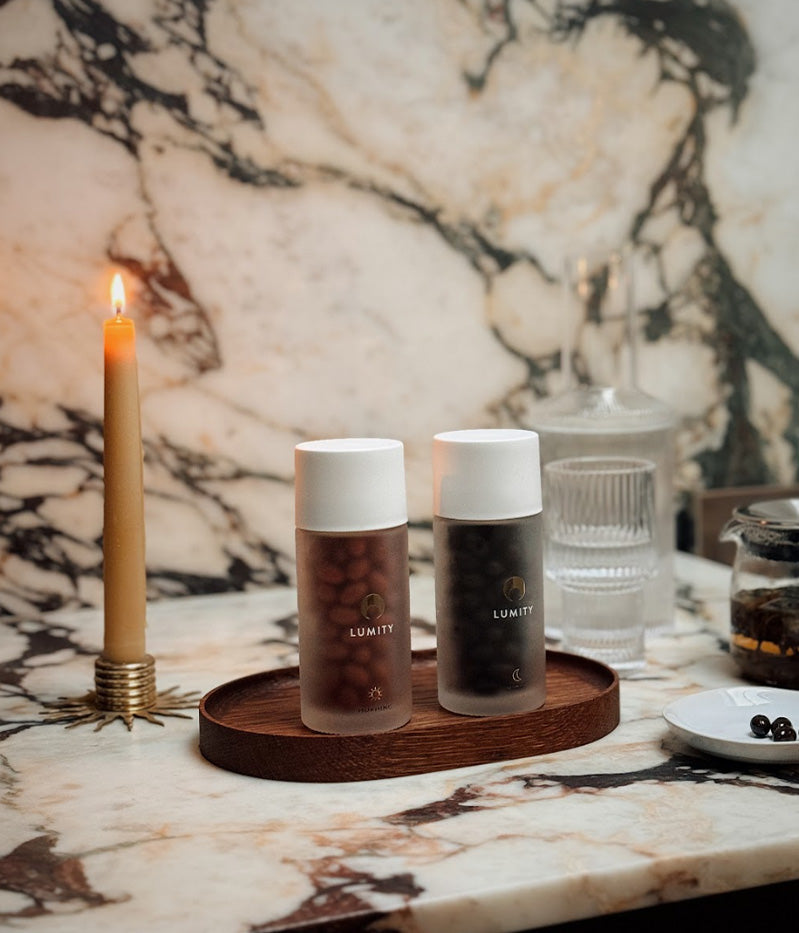 Morning & Night supplement bottles on counter with tea and candles