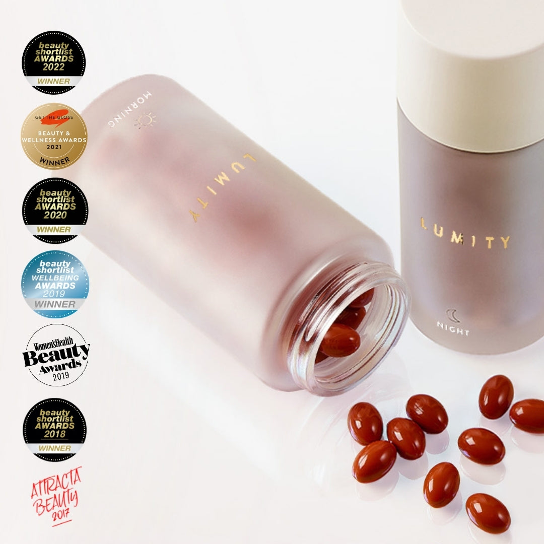 Two Lumity supplement bottles — MORNING tipped with brown capsules spilling, NIGHT upright; award badges column at left.