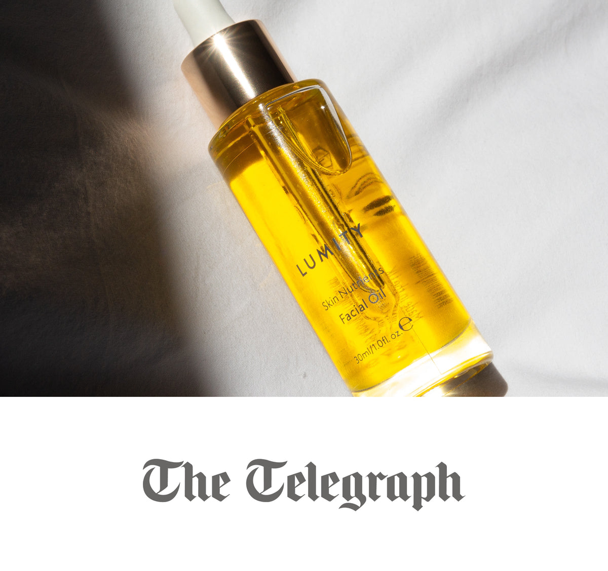 Lumity Skin Nutrients glass facial oil bottle with dropper, yellow oil, 30ml, tilted diagonally on white surface