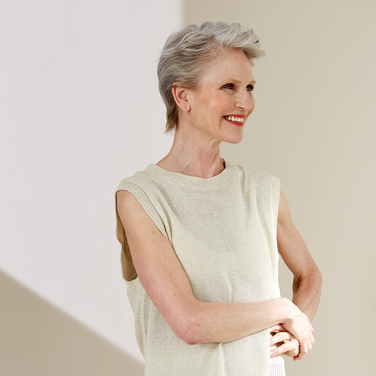 Older woman with short grey hair smiling