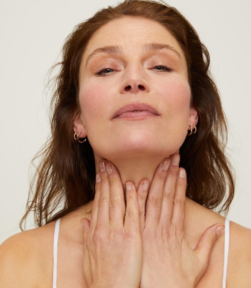 Female model with hands on neck