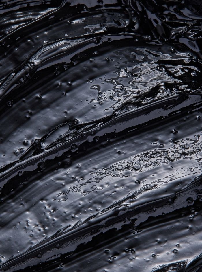 glossy black texture shot of the Lumity cleansing balm 