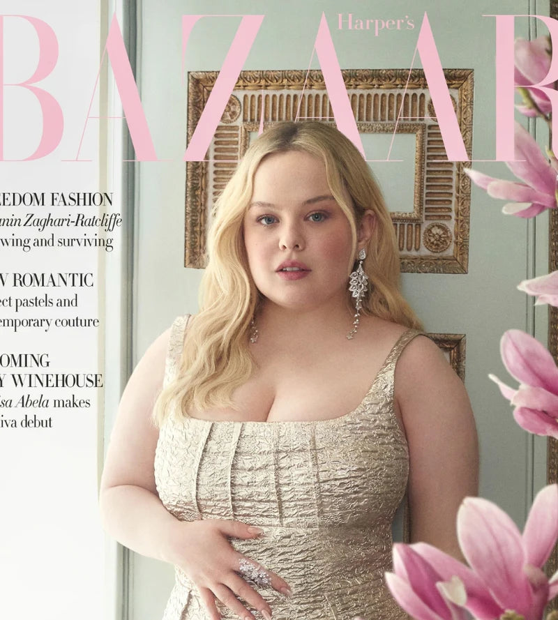 Harper's Bazaar magazine cover with a actress Nicola Coughlan in a gold dress and floral decorations.