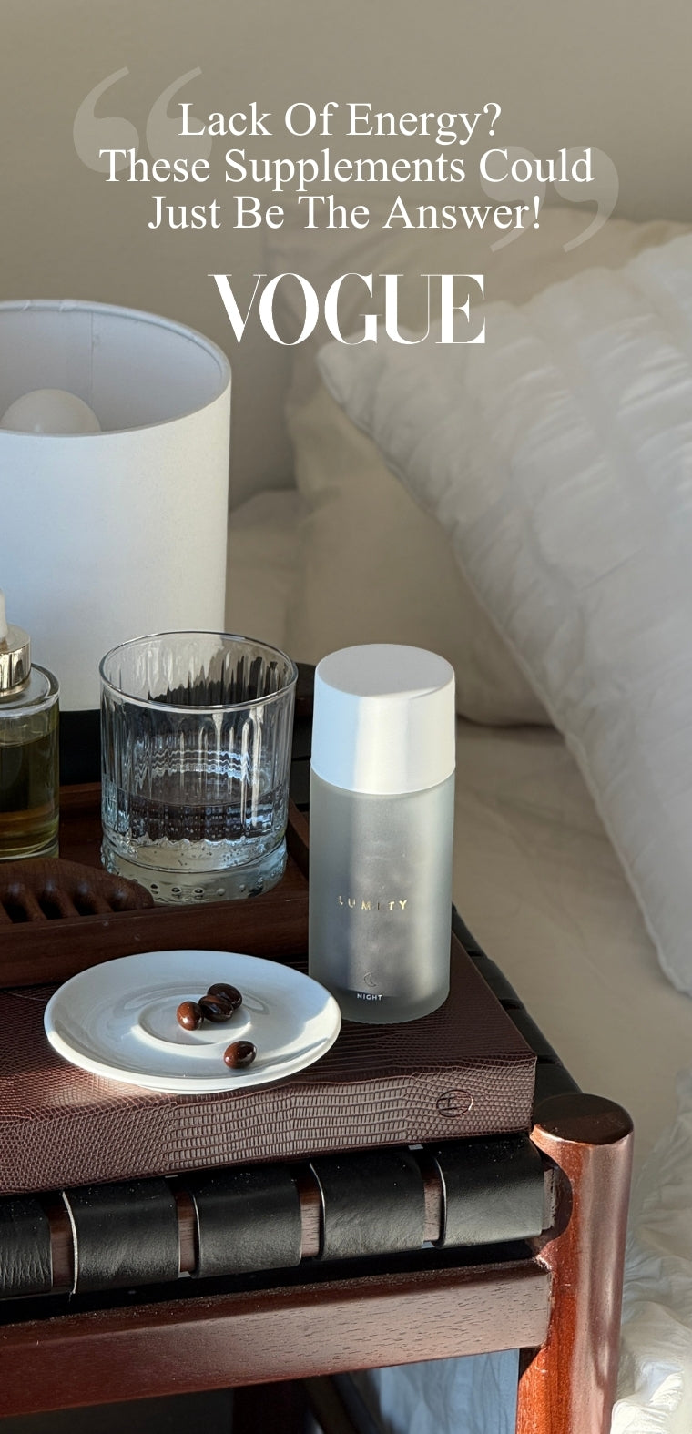 Vogue advertisement for supplements on a table with a glass of water and a plate.