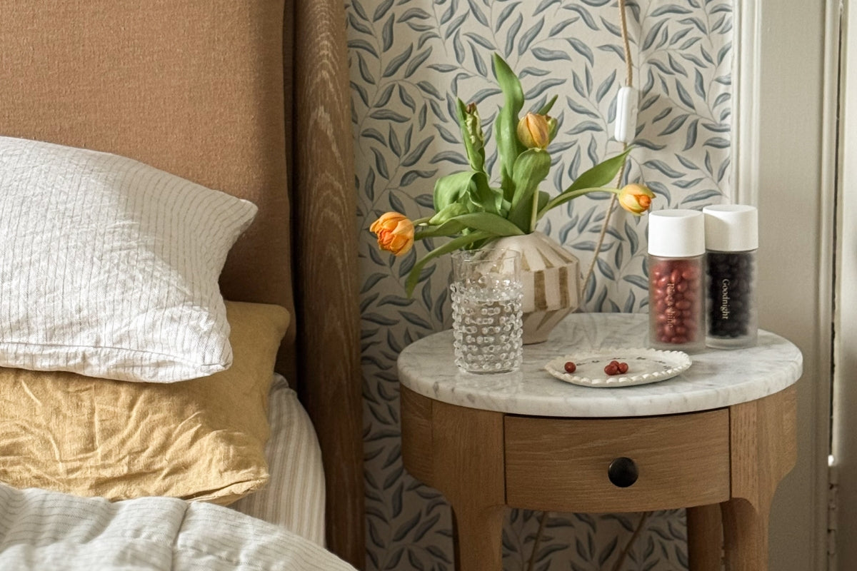 Lifestyle shot of Morning & Night supplement bottles on bedside table