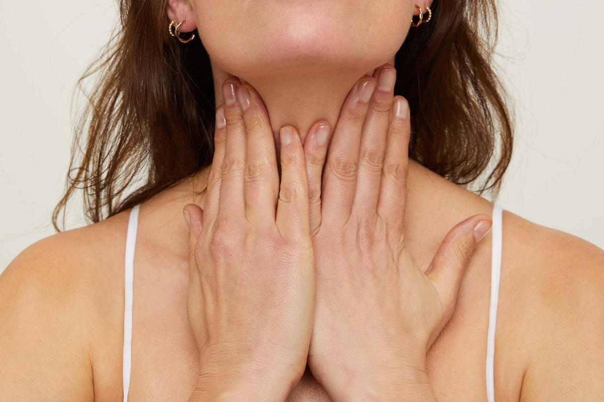 Woman applying Facial Oil to her neck