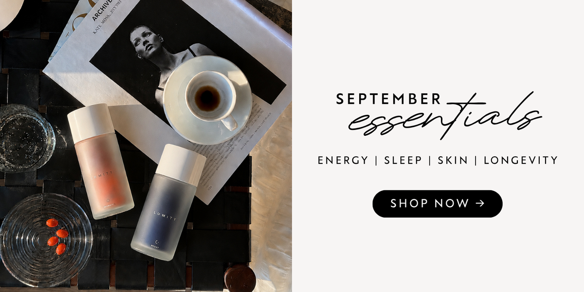 Two Lumity supplement bottles—Morning peach-pink and Night gray-navy—flat lay with red capsules on a dish and coffee cup.