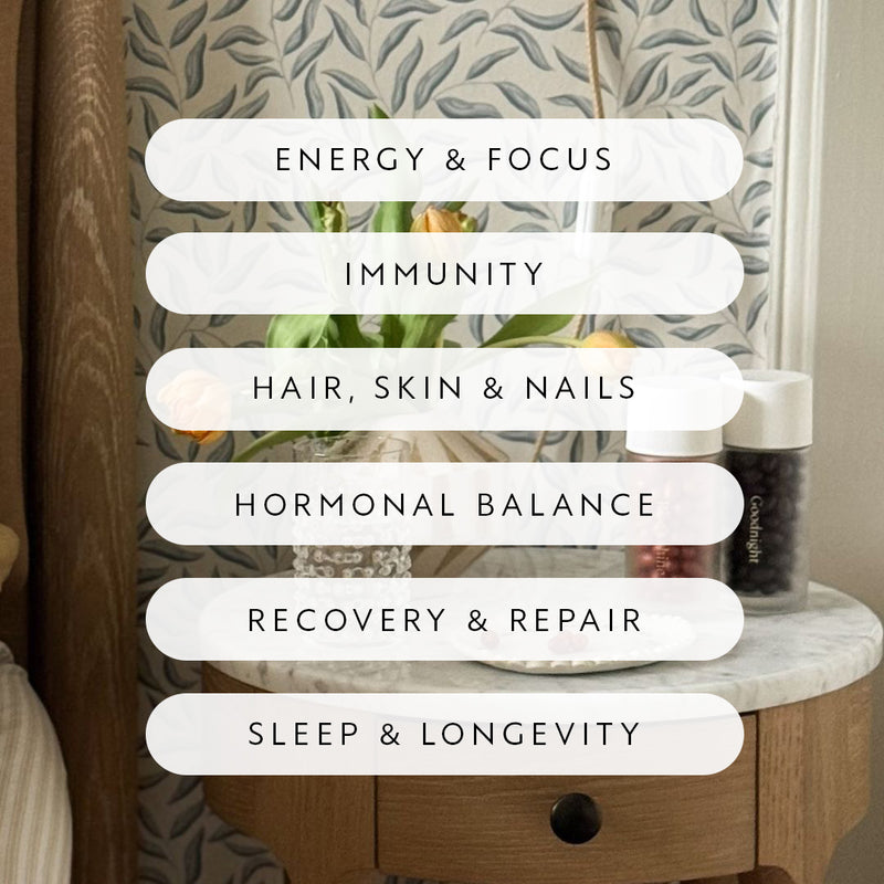 Benefits of supplements including energy, immunity, hair, hormonal balance, recovery, sleep, and longevity on a bedside table.